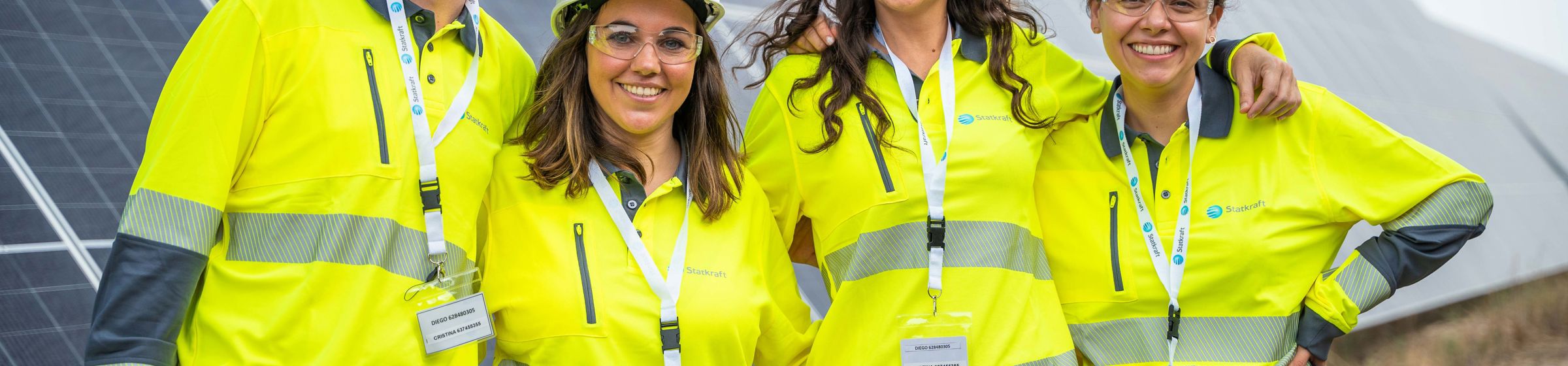 People smiling wearing yellow security clothes