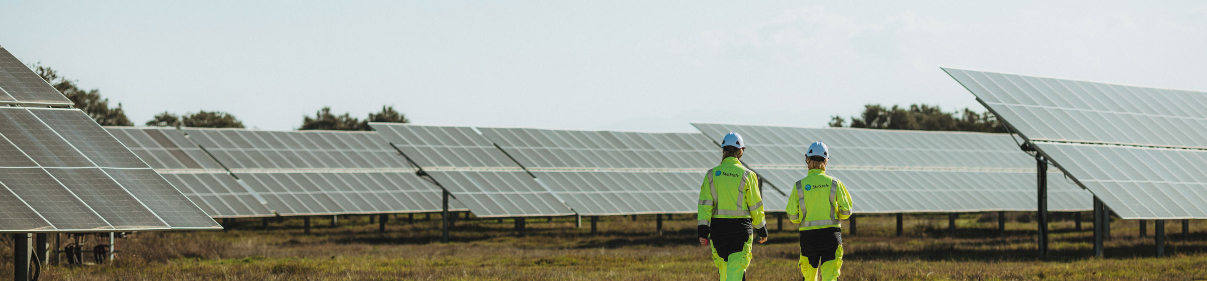 People wearing yellow security clothes on solar plant